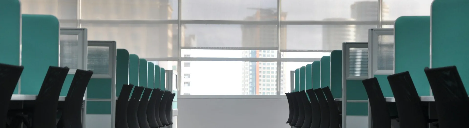Modern office interior with rows of desks and chairs